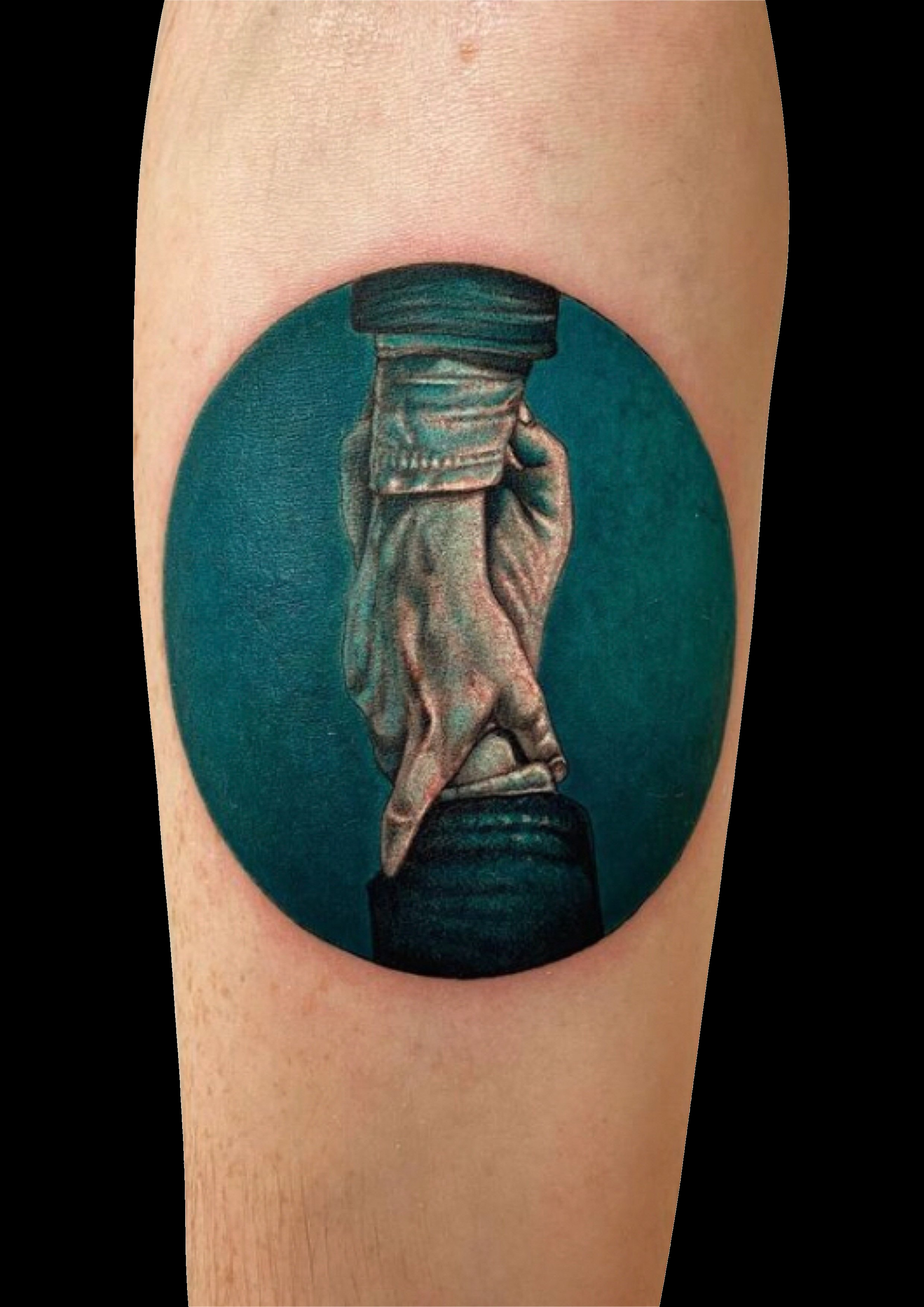 Realistic tattoo of hands holding a wrapped cylindrical object against a teal oval background.