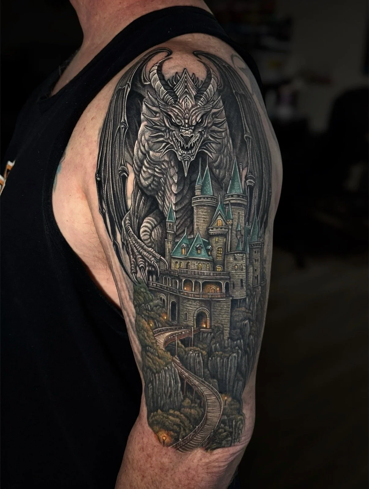 Fantasy dragon and castle tattoo with a winding railway, by Chris Kennedy.