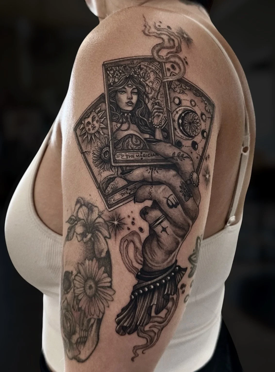 Black and grey tarot card tattoo with The Magician, sun, moon and a hand, by Chris Kennedy.