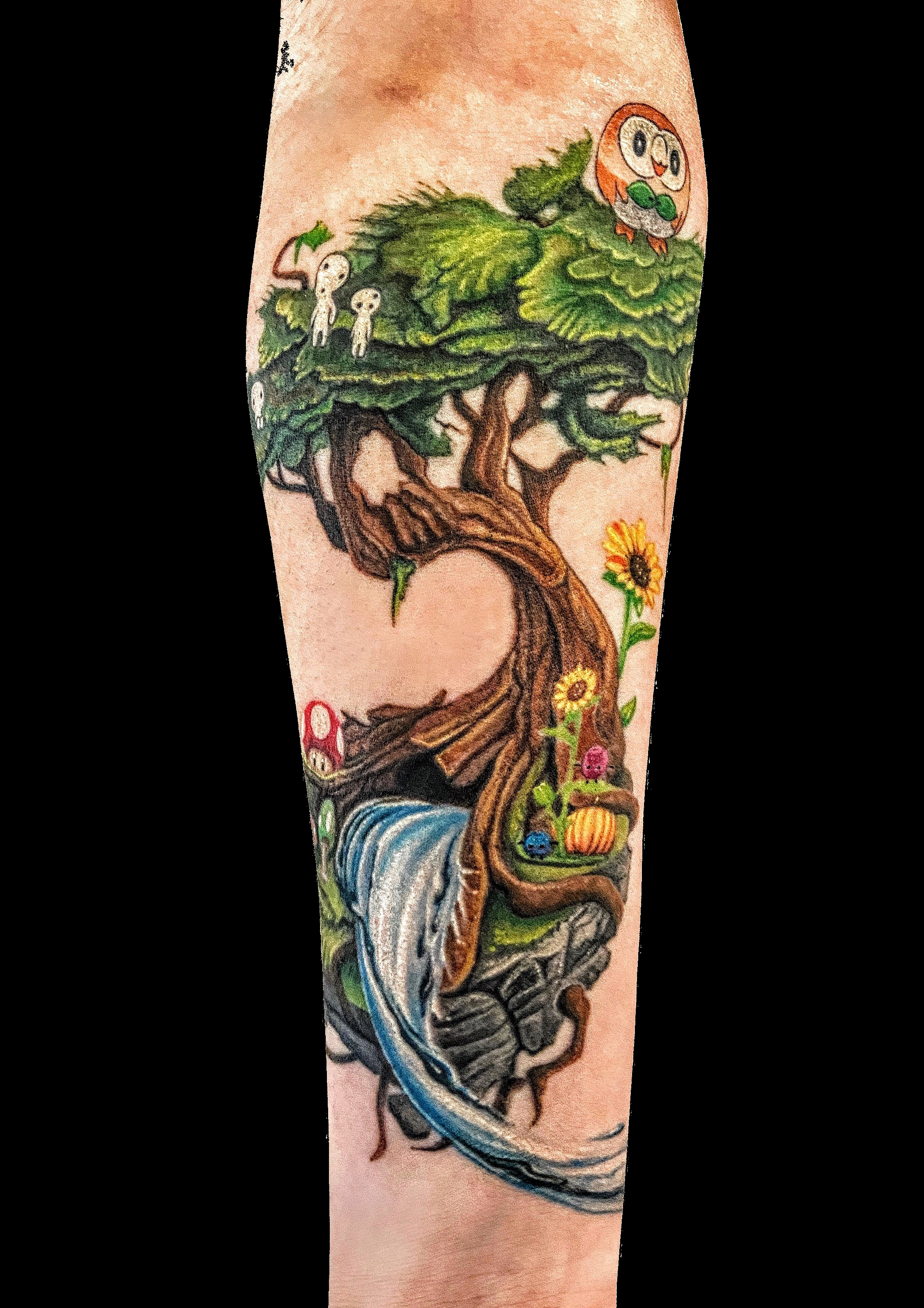 Colourful tree and woodland tattoo composition on the arm.