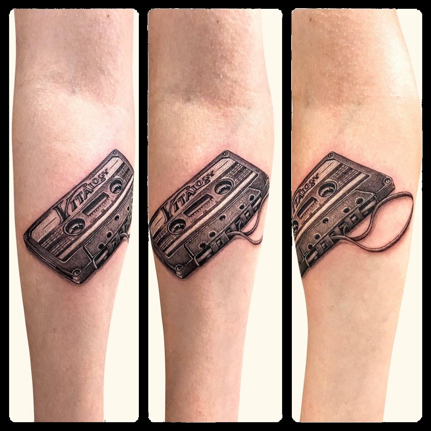 Three views of a black and grey cassette tape tattoo.