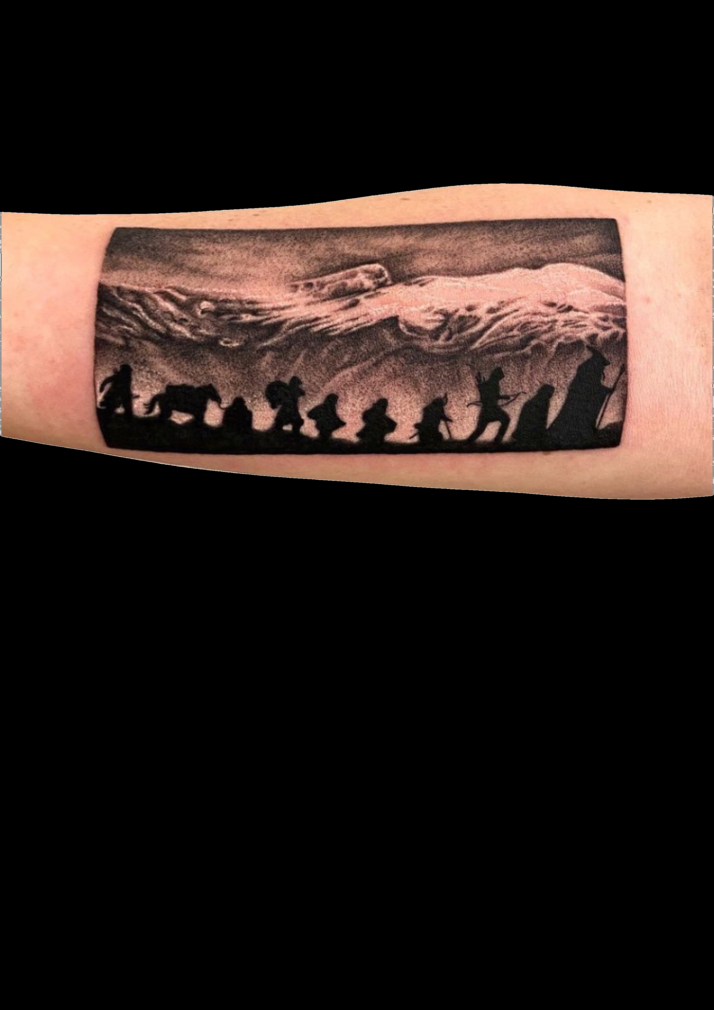 Black and grey landscape tattoo with mountains and a row of silhouetted figures.