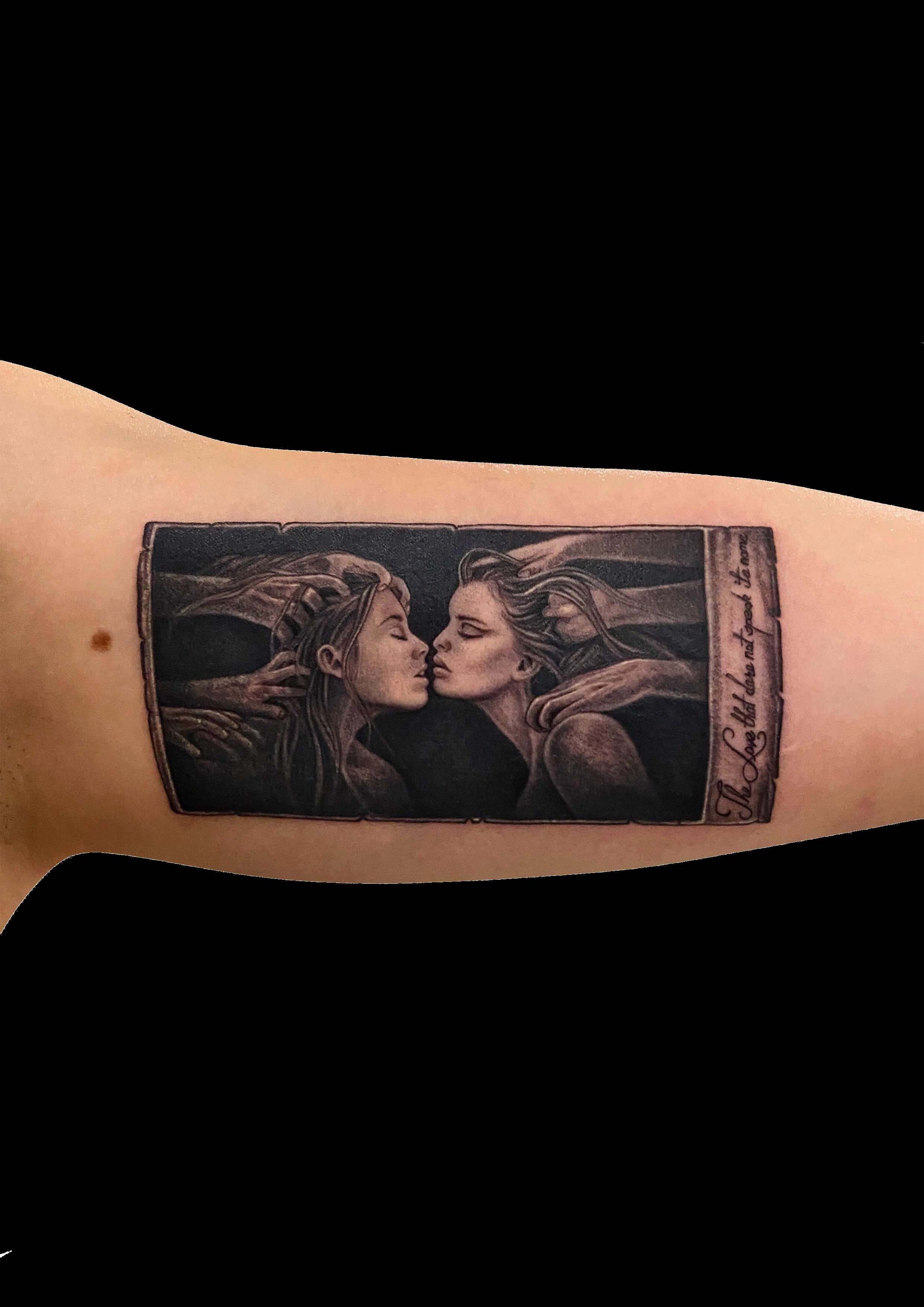 Black and grey portrait tattoo inside a rectangular frame.