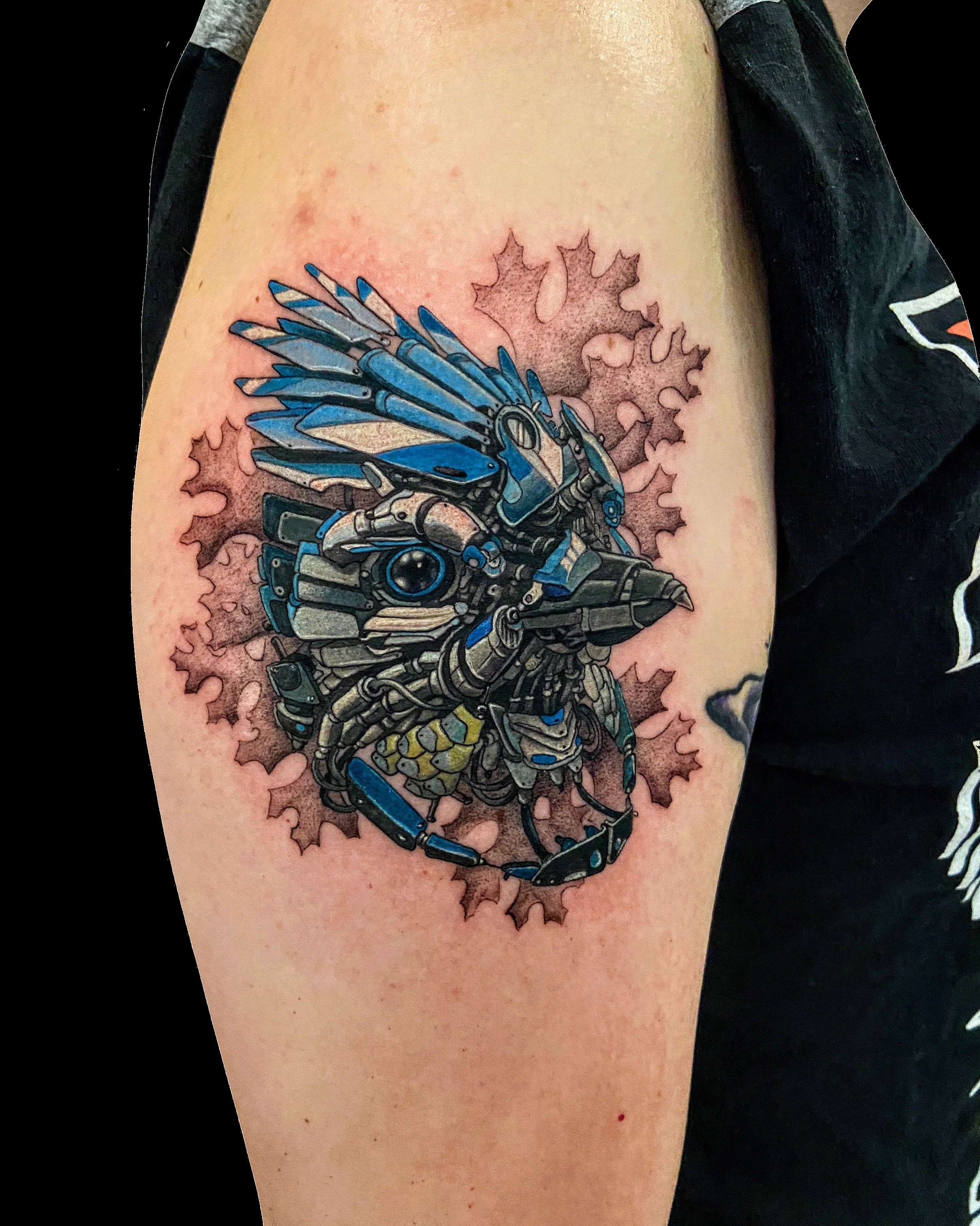 Blue dragon tattoo framed by pink blossoms.
