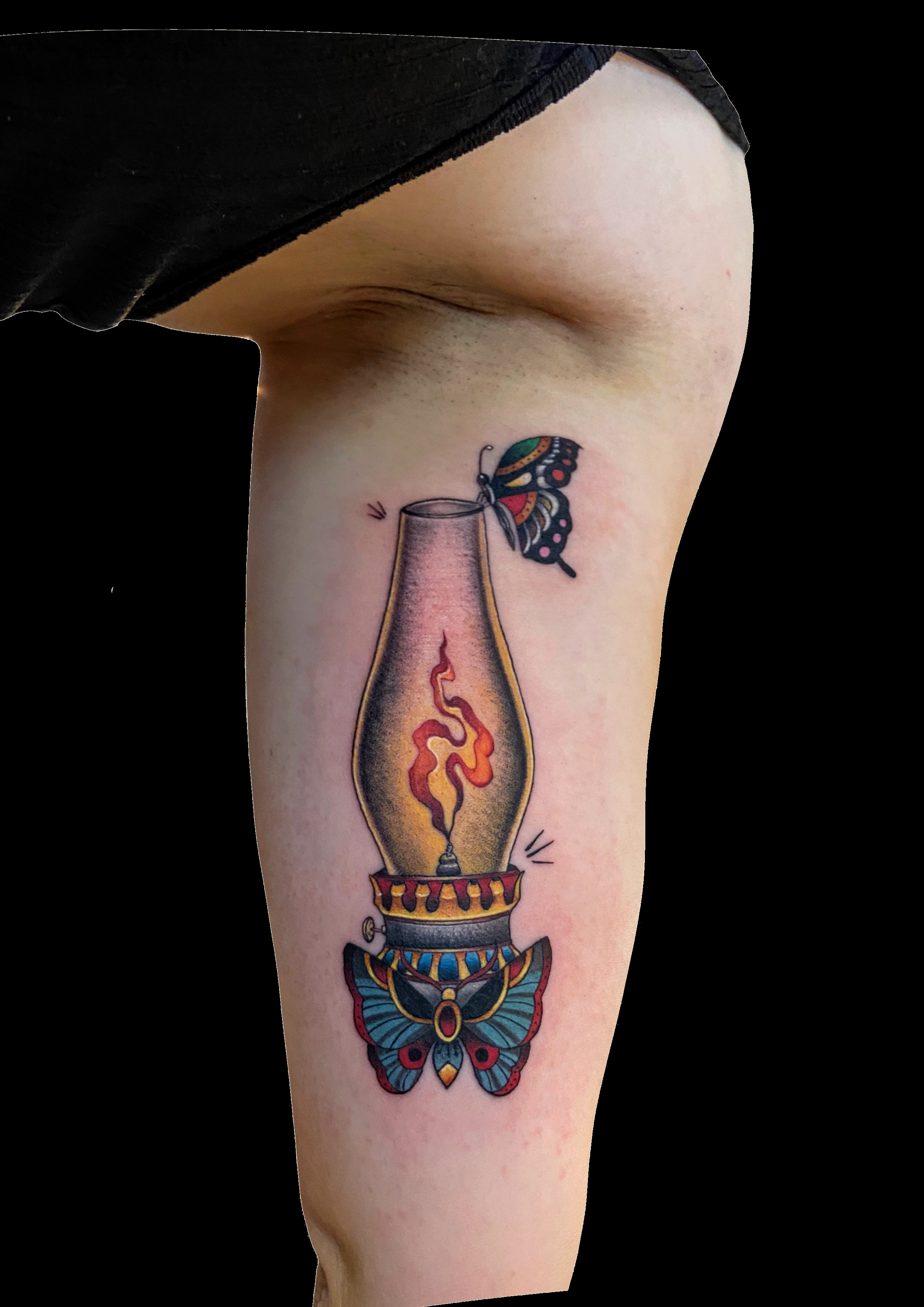 Oil lamp tattoo with a glowing flame and decorative base.