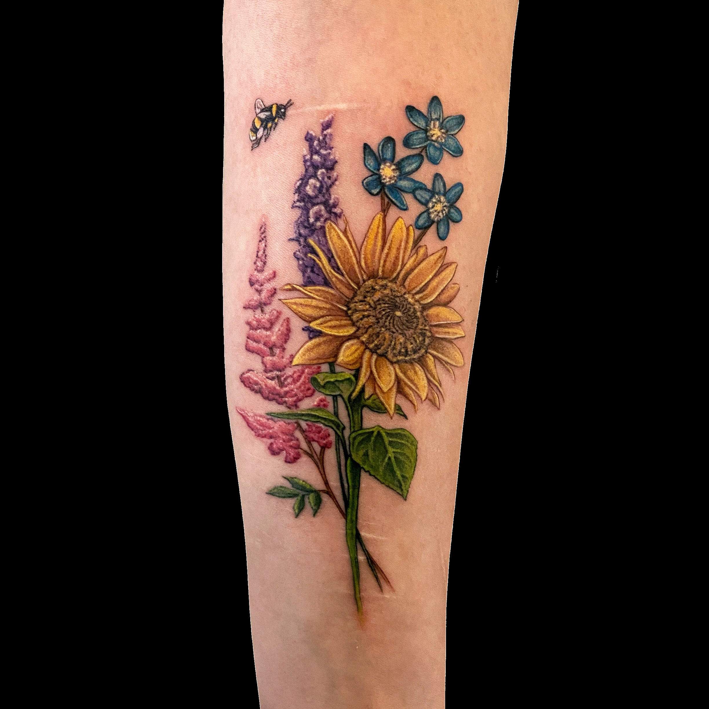 Colourful bouquet tattoo with pink, yellow and blue flowers.