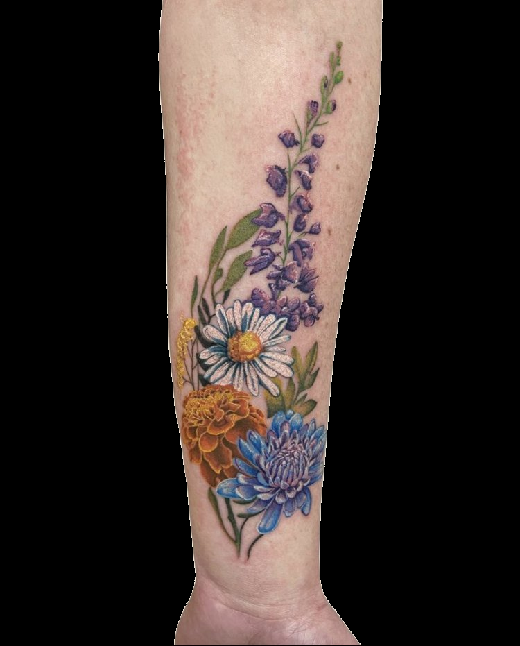 Colourful floral tattoo composition along the lower leg.