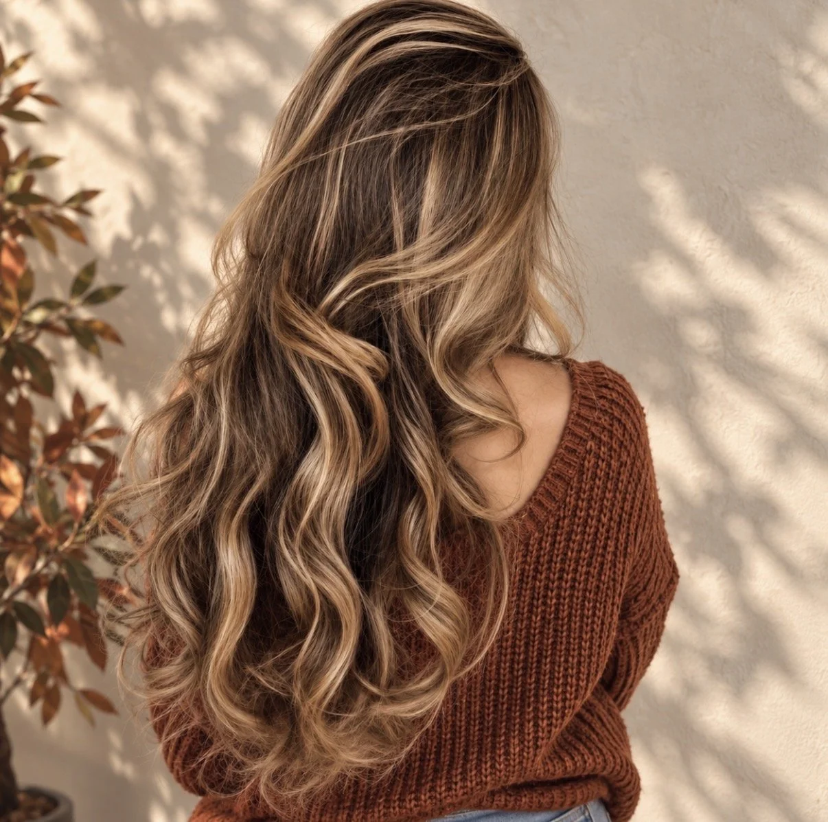 Long dimensional blonde balayage hair with soft waves at Zen Den Salon & Boutique in Encinitas, CA.