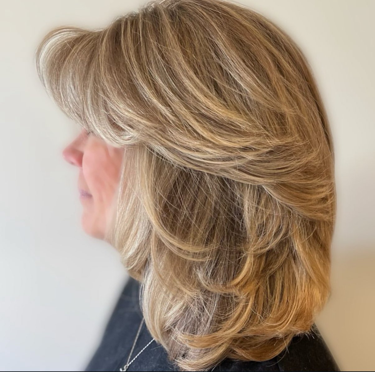 Layered blonde cut with soft highlights and a shine-enhancing gloss at Zen Den Salon Encinitas.