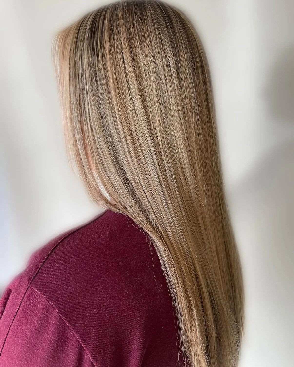 Multi-tonal blonde highlights blended with warm and cool tones for a natural, beachy shimmer