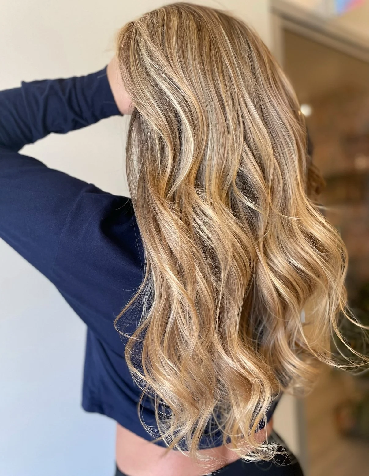 Multi-tonal blonde highlights blended with warm and cool tones for a natural, beachy shimmer