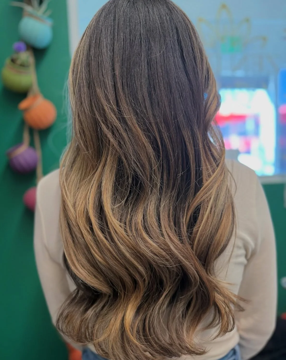 Blonde color and length-enhancing extensions with a soft, healthy finish at Zen Den Salon Encinitas.