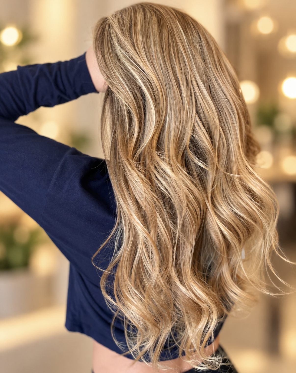 Dimensional blonde highlights with soft waves and natural-looking color by Zen Den Salon & Boutique, a hair salon in Encinitas, CA.