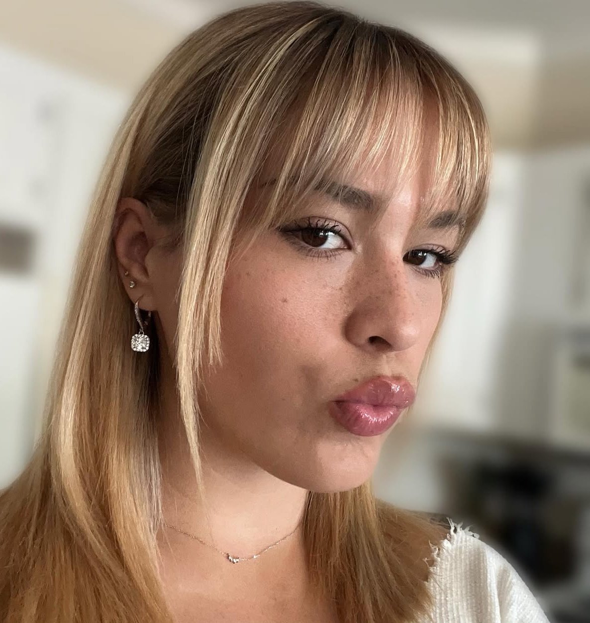 Blonde color with soft face-framing highlights and a glossy finish at Zen Den Salon in Encinitas.