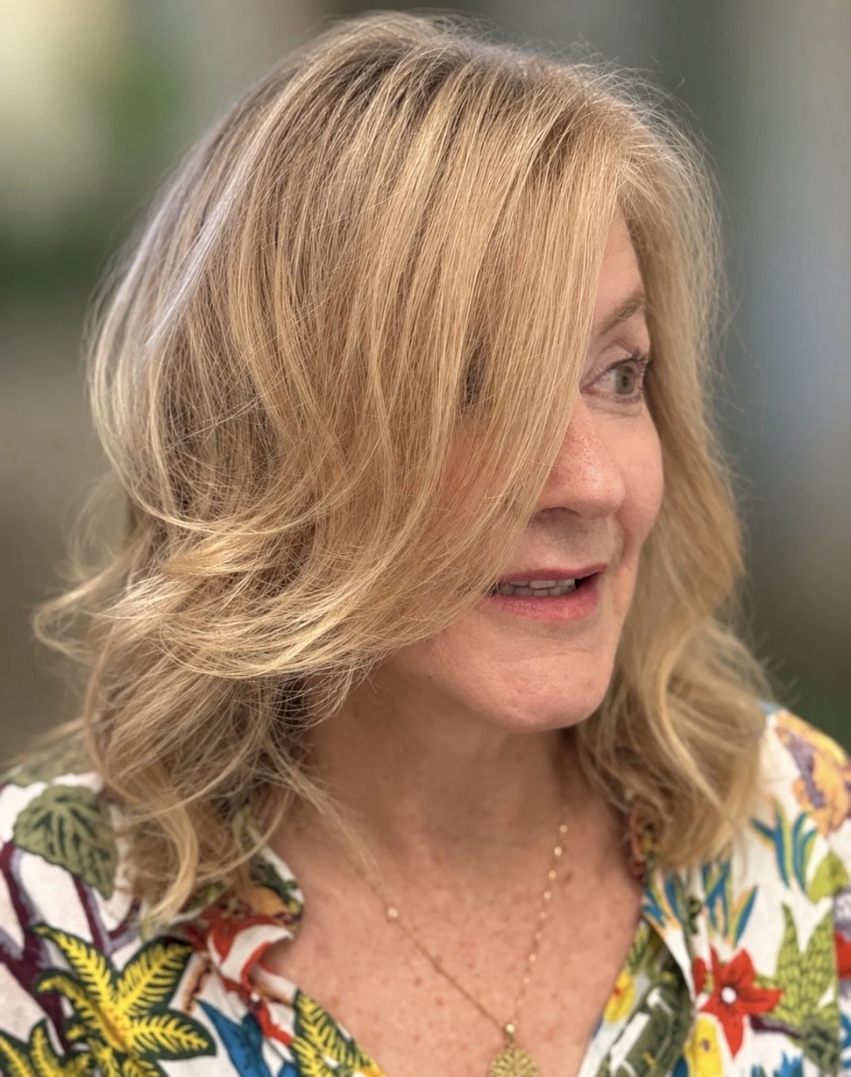 Gray blending with soft blonde highlights and gloss for natural dimension, shine, and seamless gray coverage at Zen Den Salon in Encinitas.