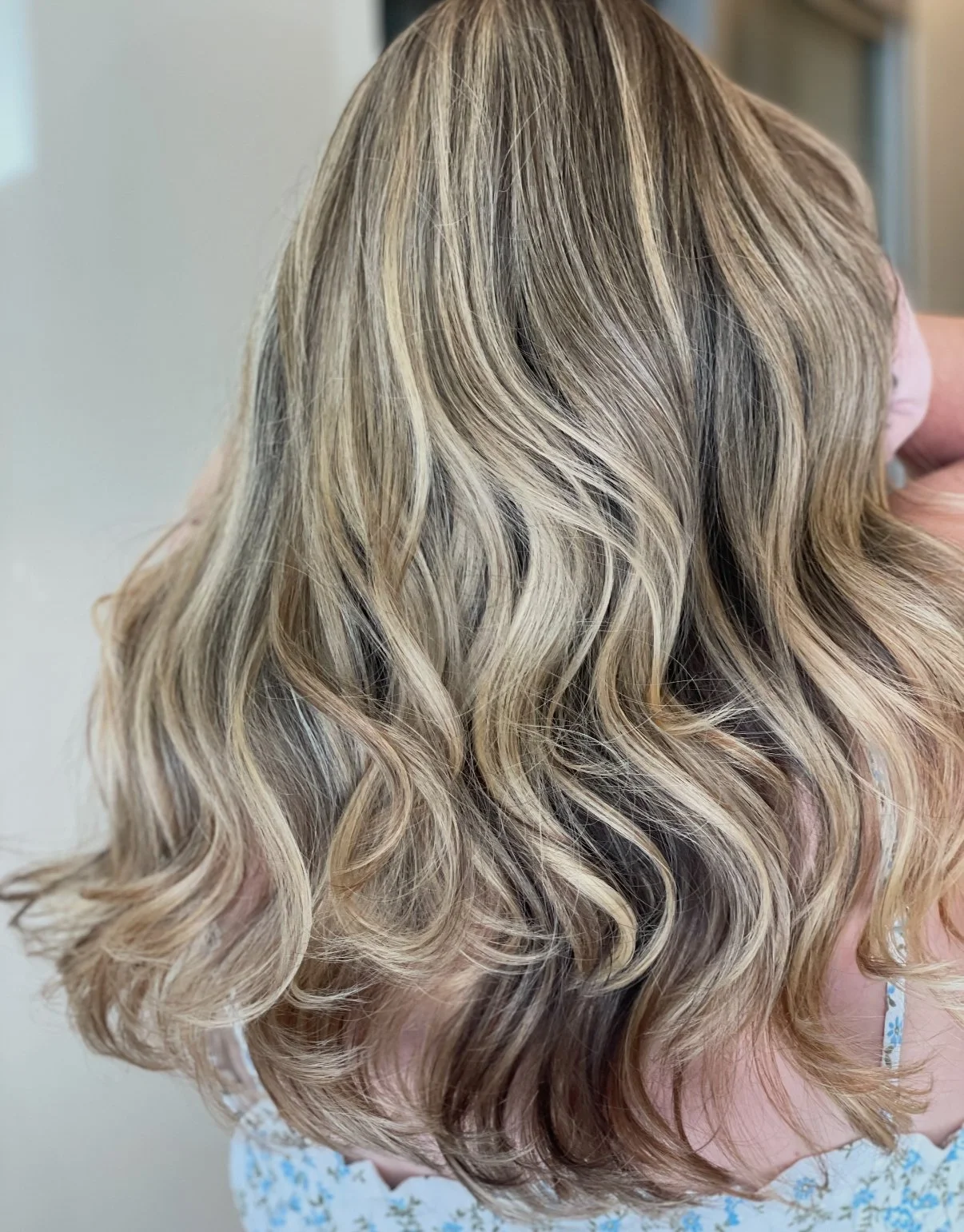 Cool-toned blonde balayage with a glossy, healthy finish at Zen Den Salon Encinitas.