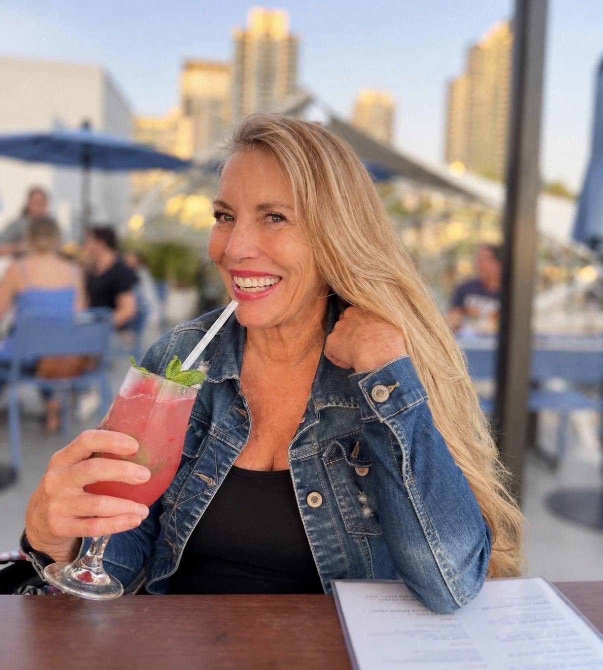 Naturally blonde hair with subtle highlights and lowlights, photographed at an outdoor restaurant.