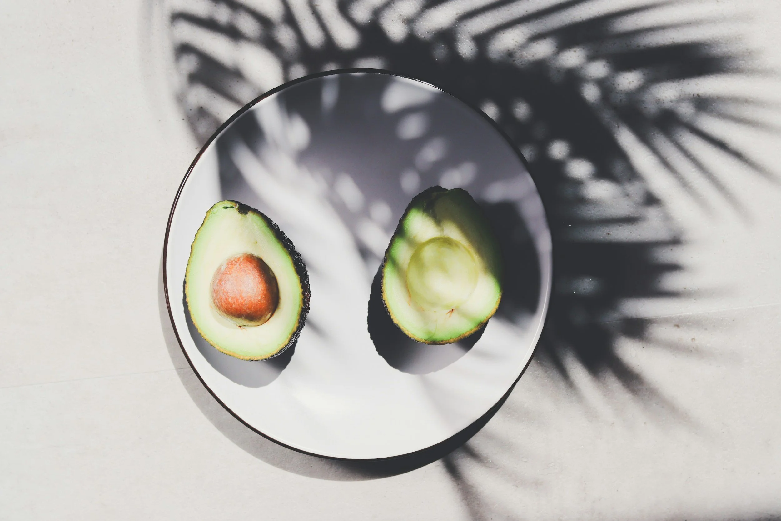 High fat Avocado with shadows from leaves