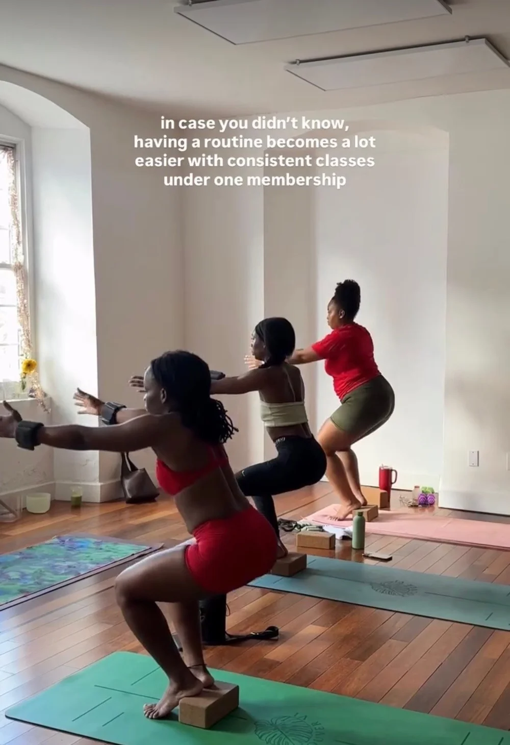 Members in a sculpt class holding a squat at Island Movement, St. Croix fitness studio