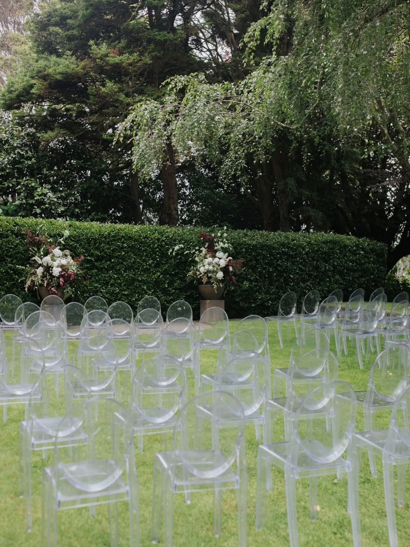 A romantic garden setting for Sarah and Craig's Taranaki Wedding

They had permanent cast urns already in their private garden, wanting to arrange flowers spilling out of them. 

Then, they also wanted to move them to the ceremony after. 

So we had 