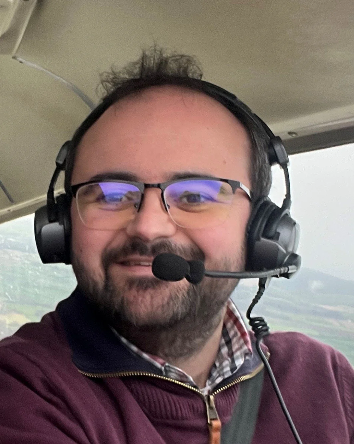 Logo for Shobdon Airfield featuring a white planes silhouette with vapor trail on a purple circular background, with the text 'SHOBDON AIRFIELD'.