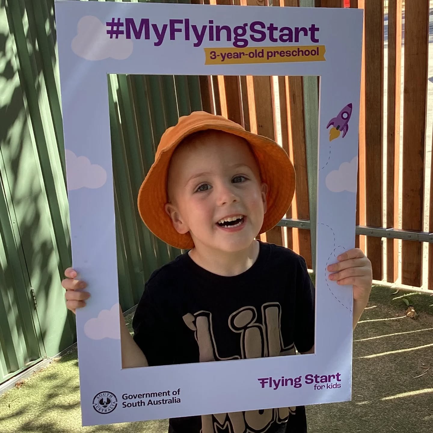 Smiling boy who attends Brightside early learning centre. The frame features playful clouds and a rocket illustration, suggesting a playful, educational event for young children. flying start program 2026