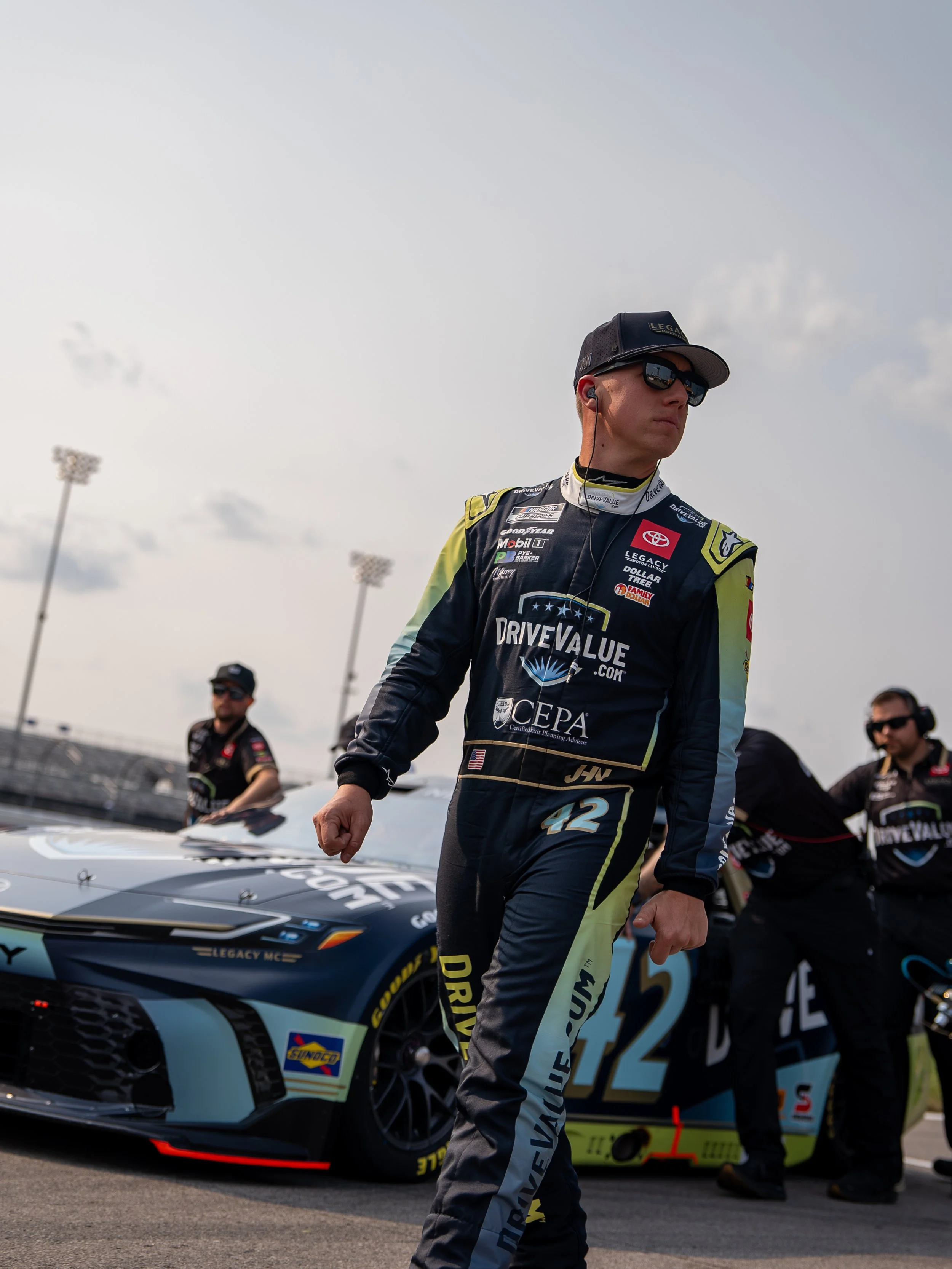 John Hunter Nemechek in the DriveValue.com firesuite, in front of the DriveValue.com car. The car on track at the Nashville Superspeedway on June 1, 2025.