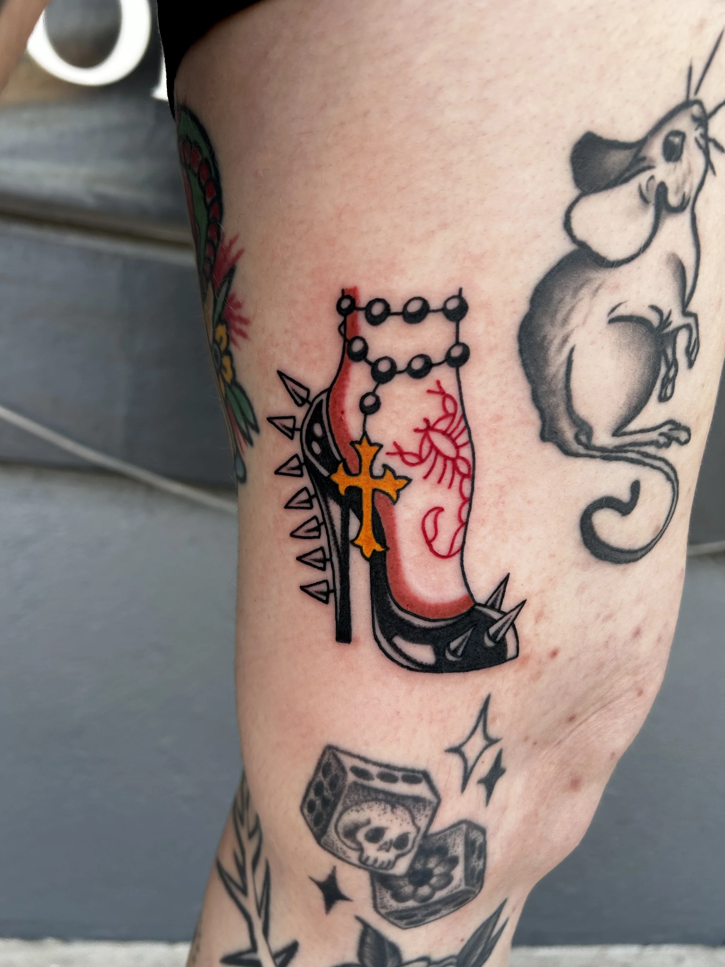 American Traditional Spike highheel shoe and chain tattoo done by Kayla by Dark Mark Ink Tattoo Studio