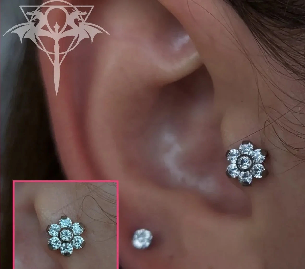 Close-up of a person's ear with two diamond earrings and a cartilage piercing, with a decorative logo overlay in the top left corner.