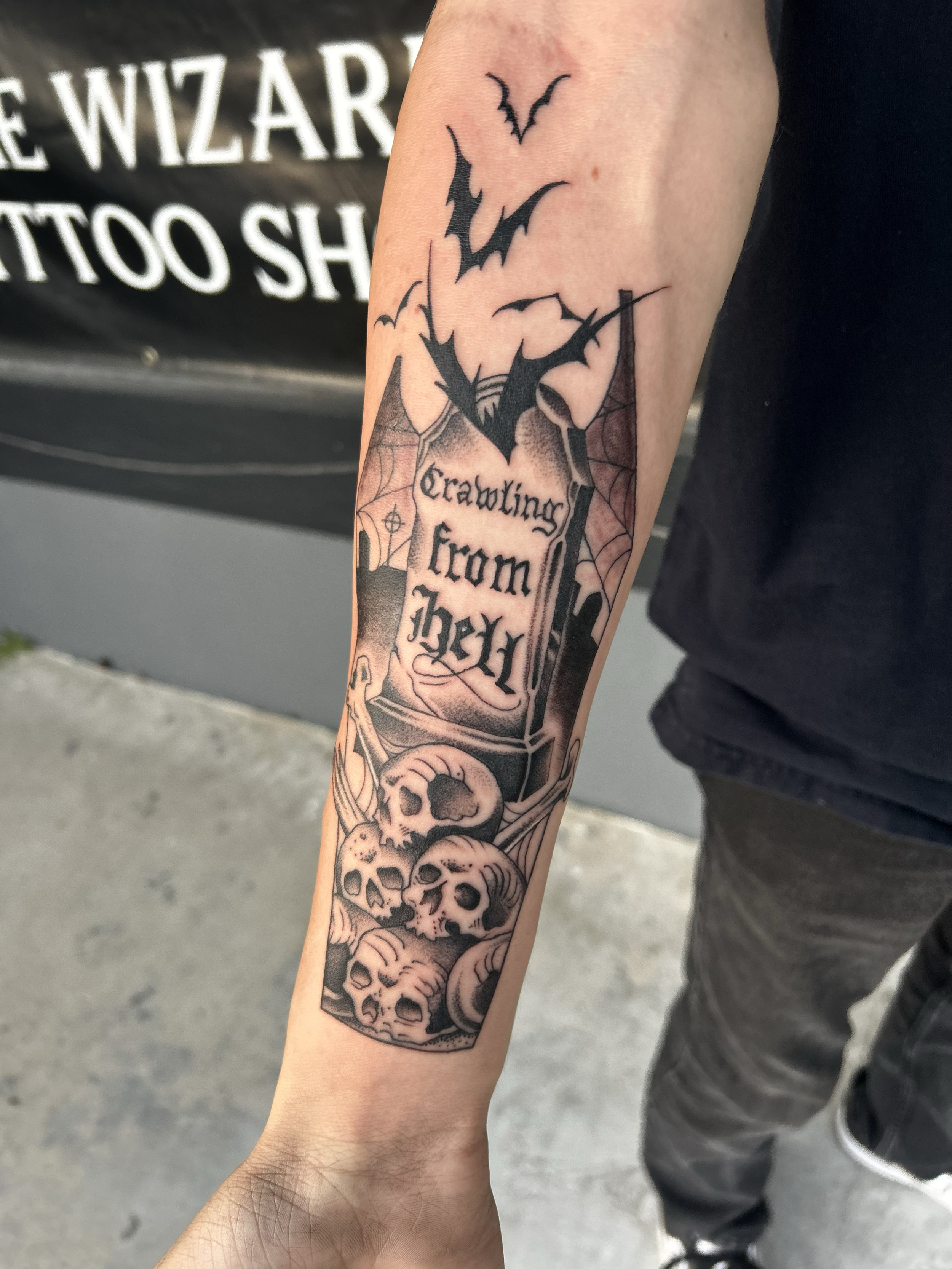 Tattoo of an urn with the inscription 'Crawling from Hell', skulls, spider webs, and bats.