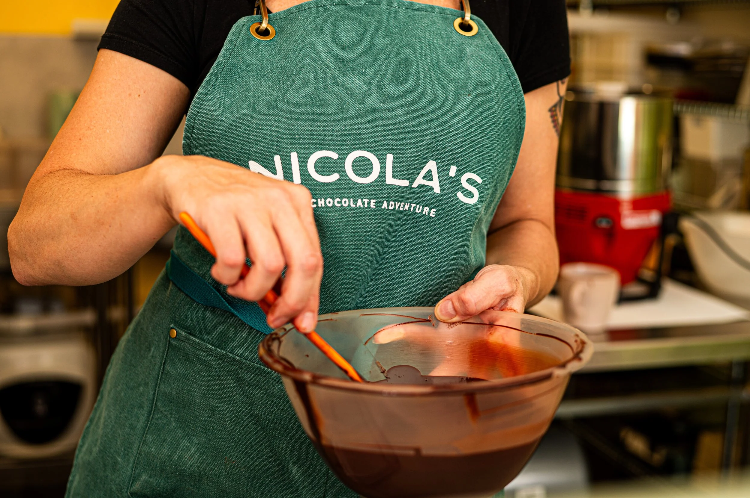 Nicola stirring melted bean-to-bar chocolate