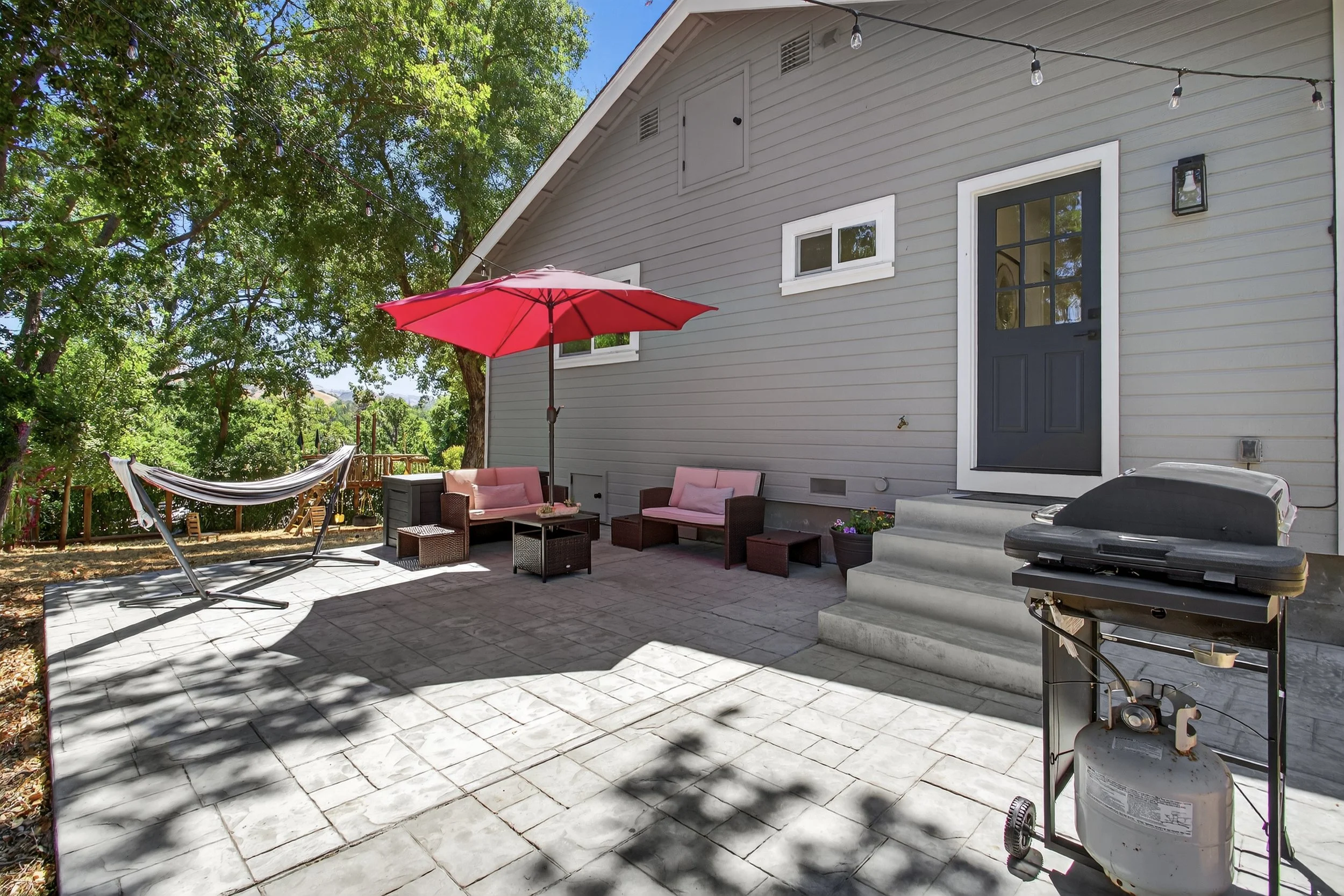 Mid term rental guests appreciate the umbrella, BBQ, and hammock 