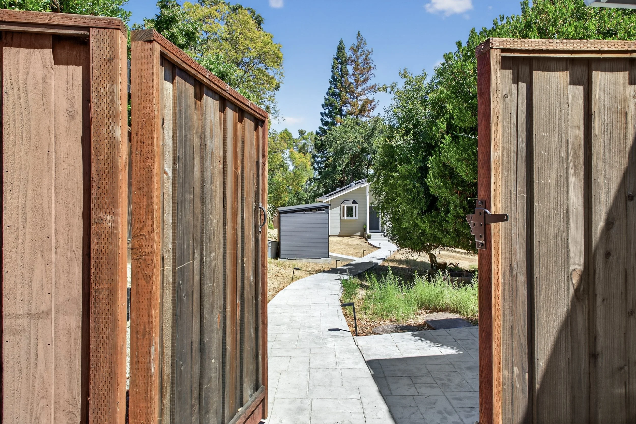 The ADU is secluded back corner position of the .53 acre yard, accessible via  a stamped concrete path