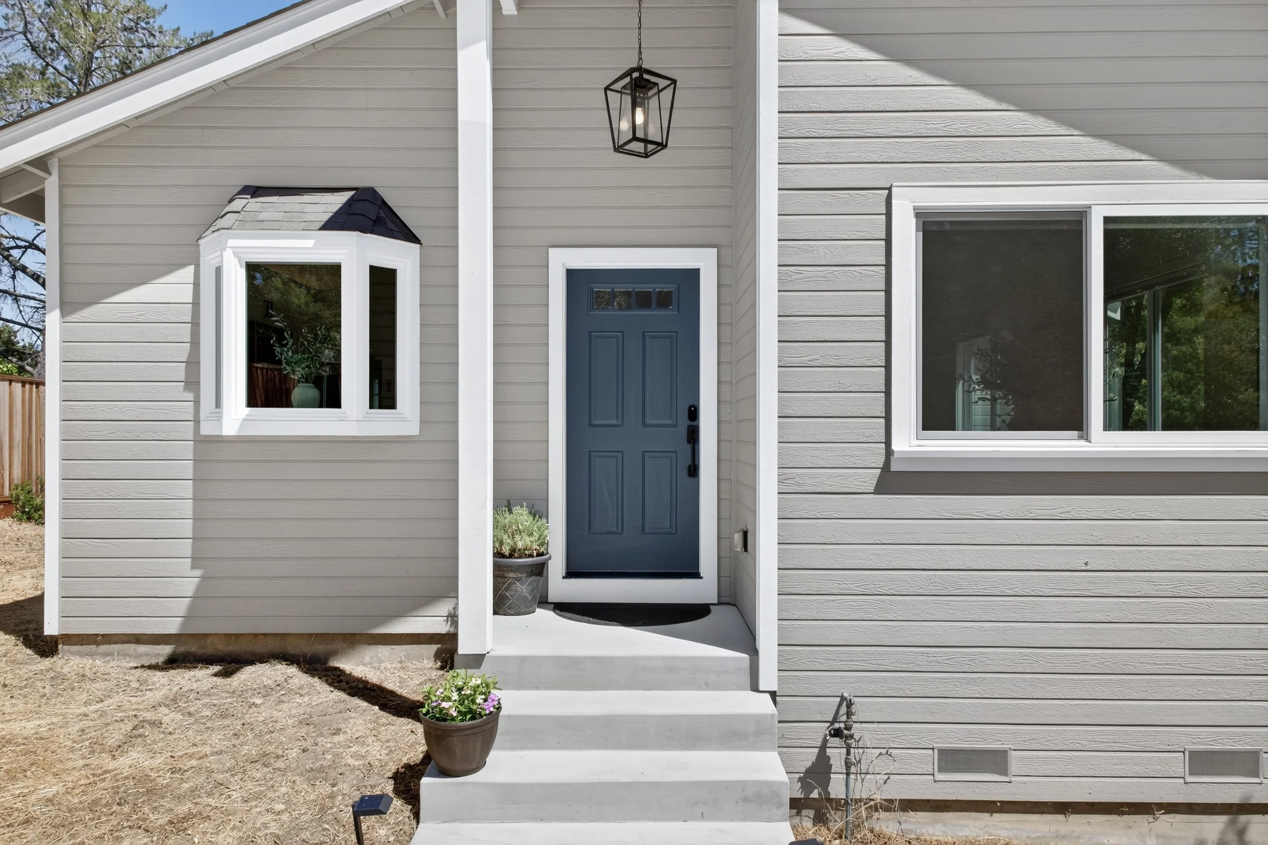 The hanging pendant light fixture is a nice way of filling the space on the covered porch. Sometimes I wish we had a window up there.