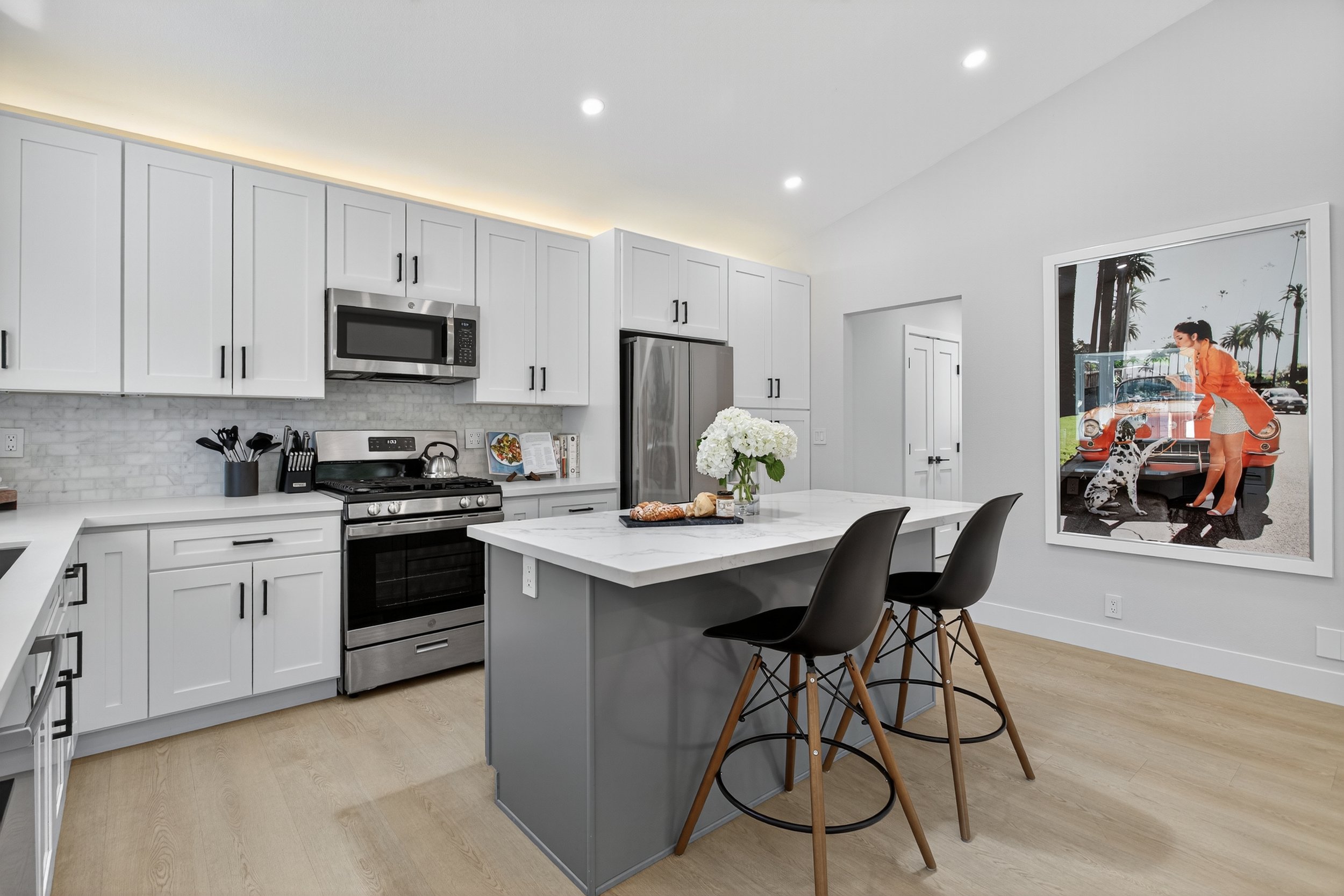 We decided not to put a door from the kitchen to the hallway, but we framed it so we could always add one, or we could even add a barn door (and move the art).