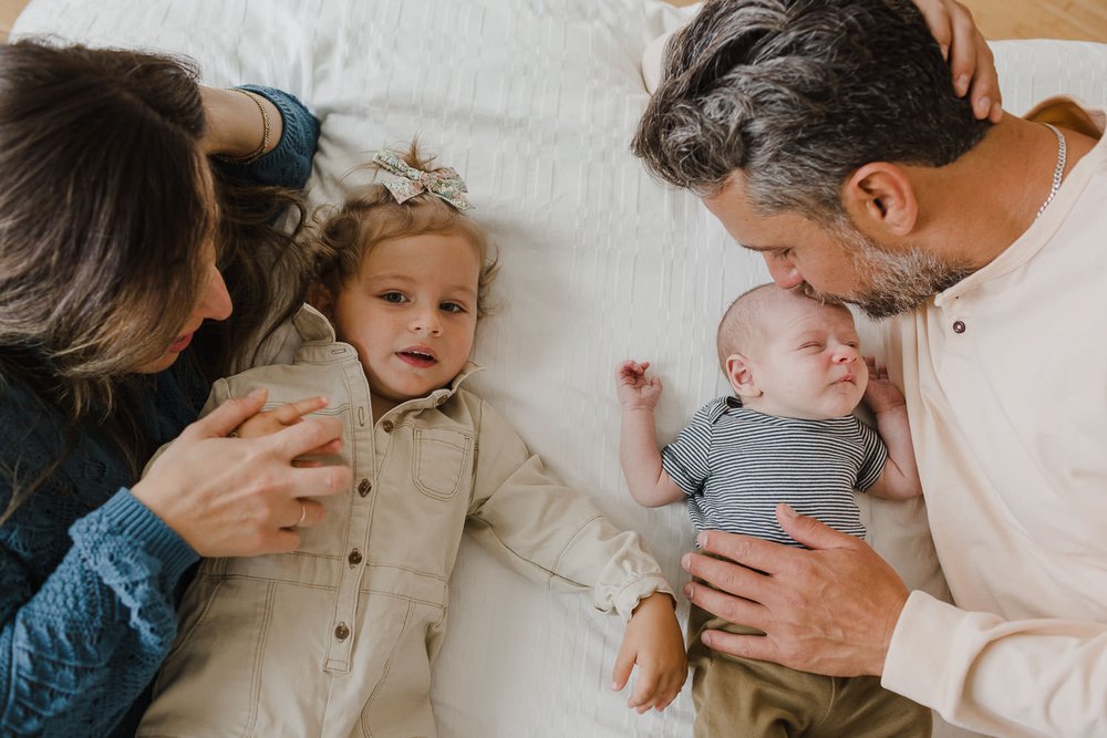Lifestyle family portraits at home with toddler and newborn