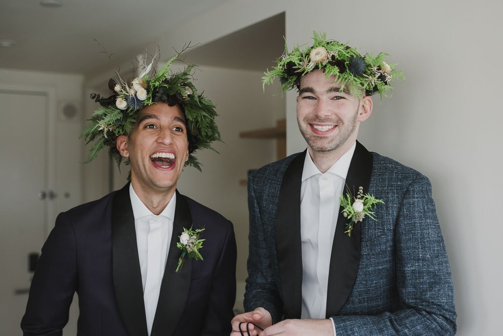 Two grooms in flower crowns