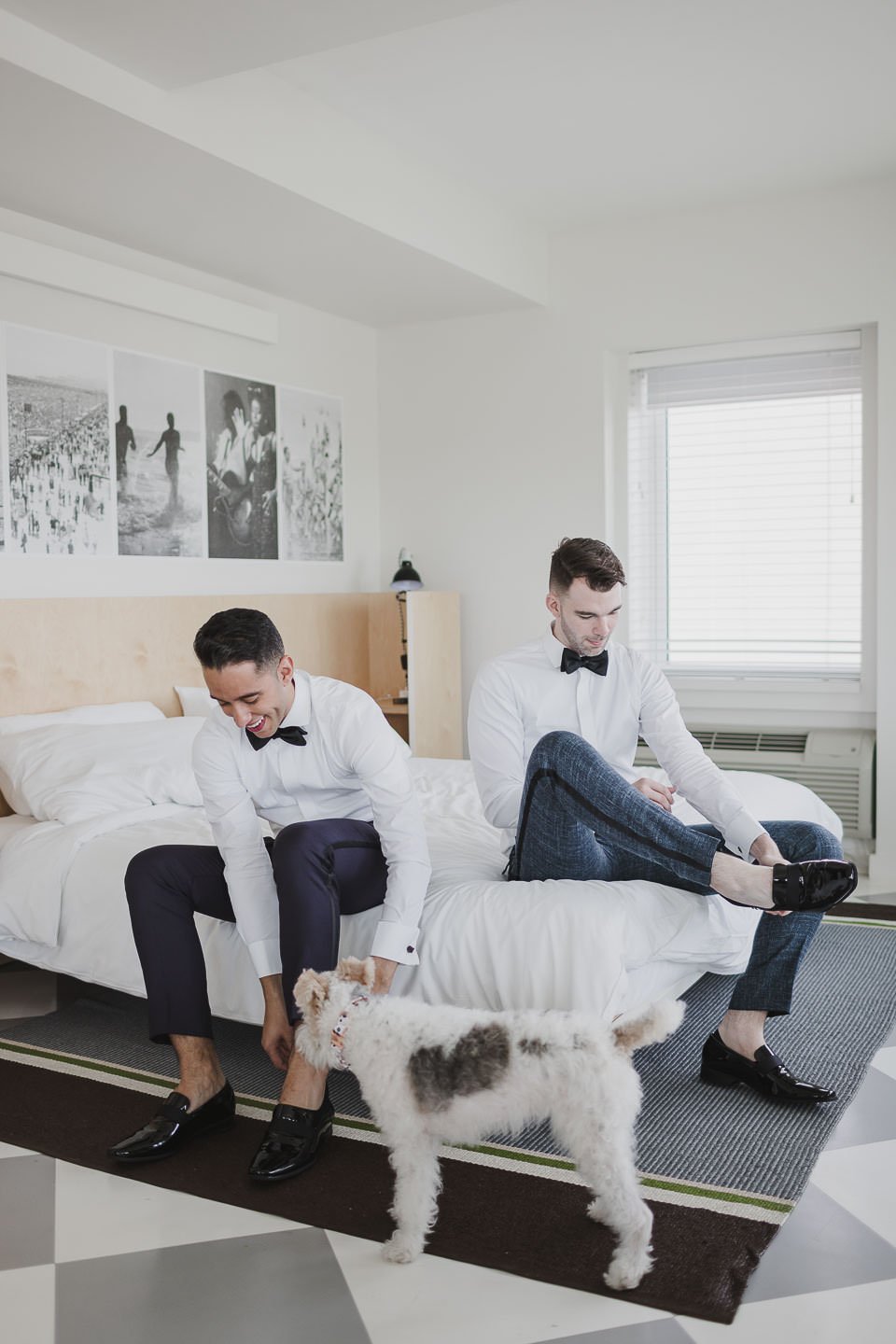 Two grooms getting ready together on wedding morning