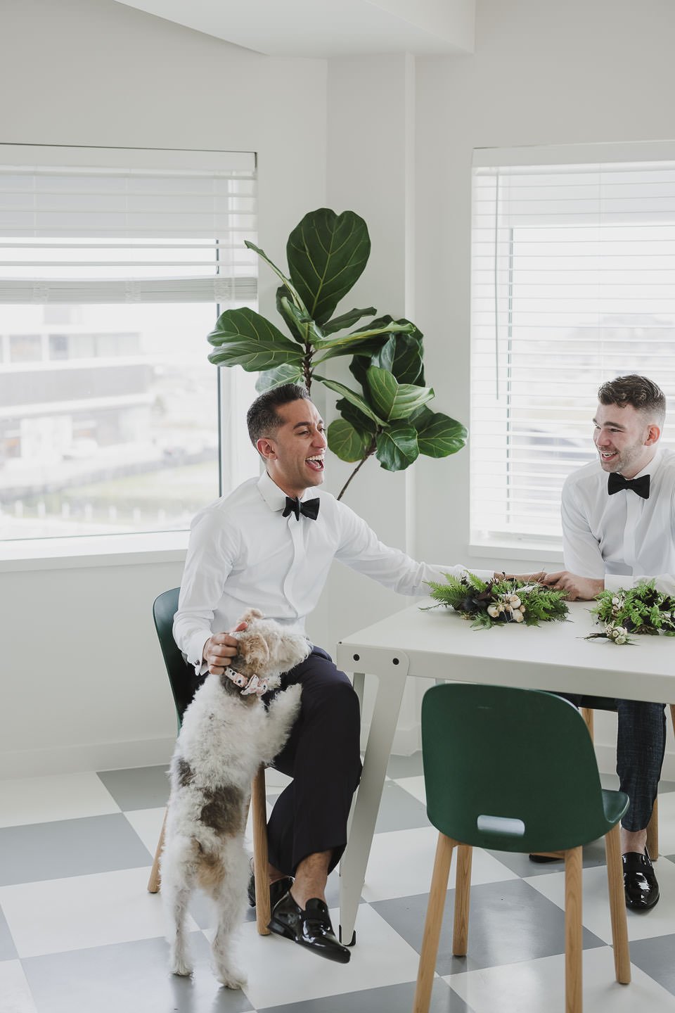 Two grooms getting ready together on wedding morning