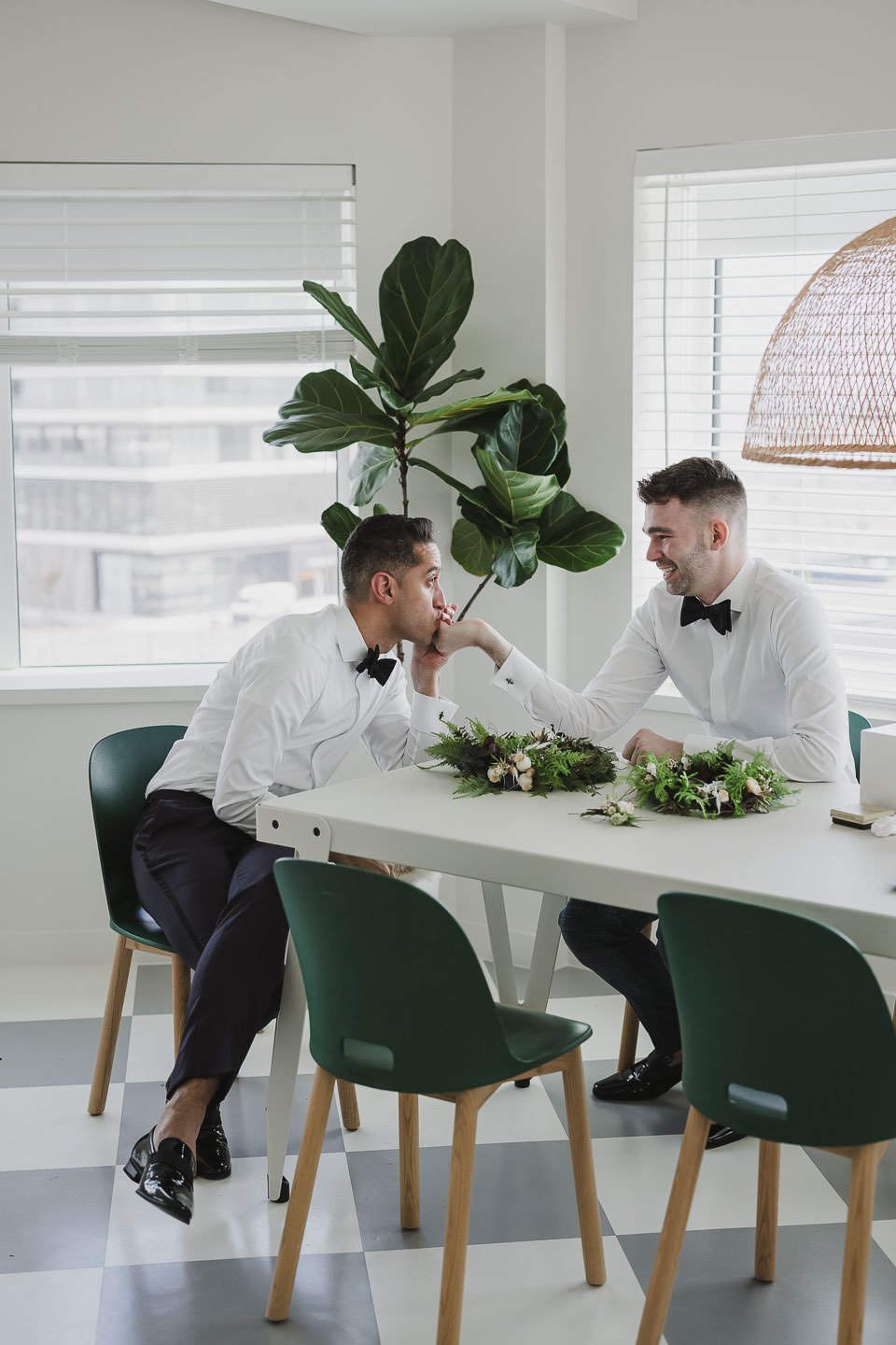 Two grooms getting ready together on wedding morning