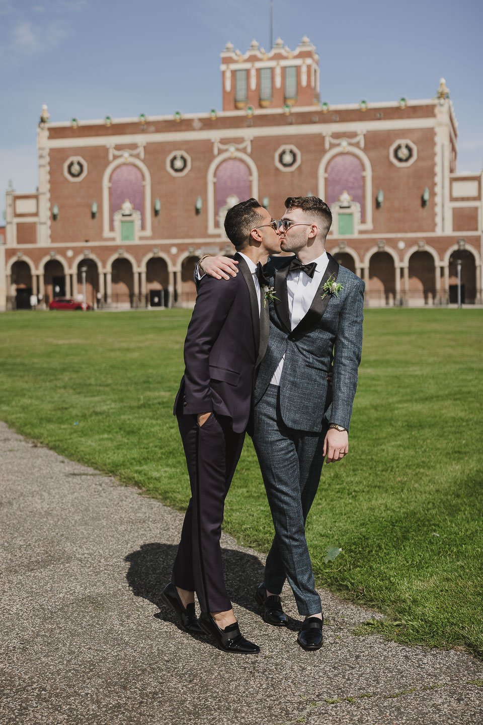 Two grooms kissing