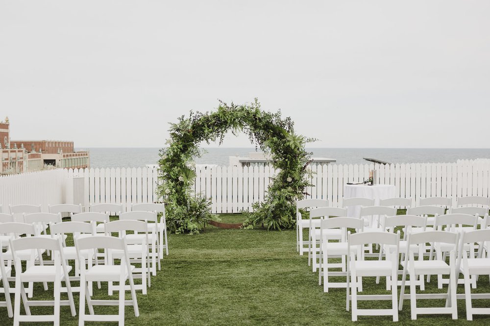 Midsommar inspired lush greenery wedding ceremony arch