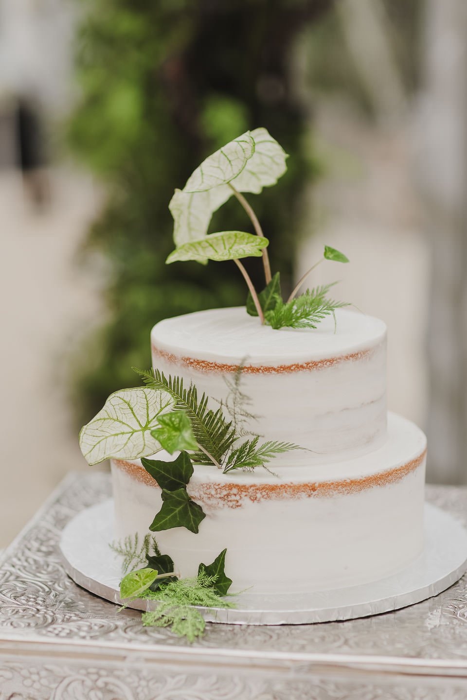 White wedding cake with simple greenery