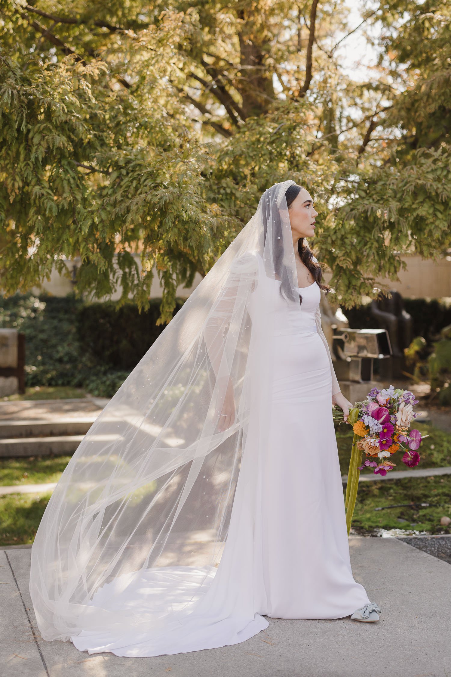 Bride wearing Sarah Seven Rosanna gown and pearl veil at sculpture garden wedding
