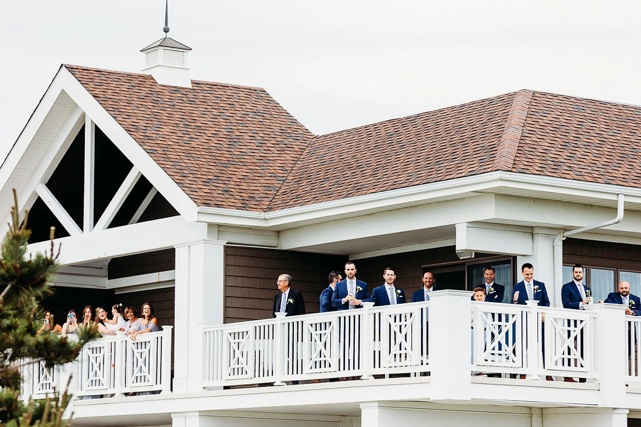 bridal party watching first look between bride and groom