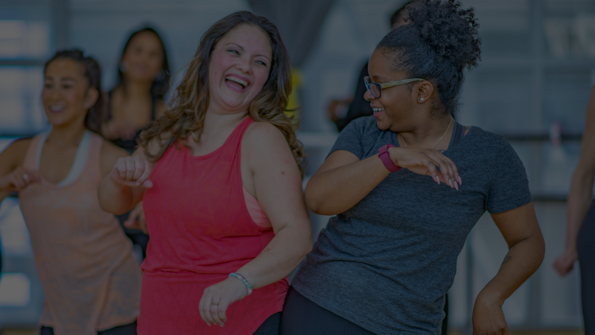 Two women laughing during a dance class