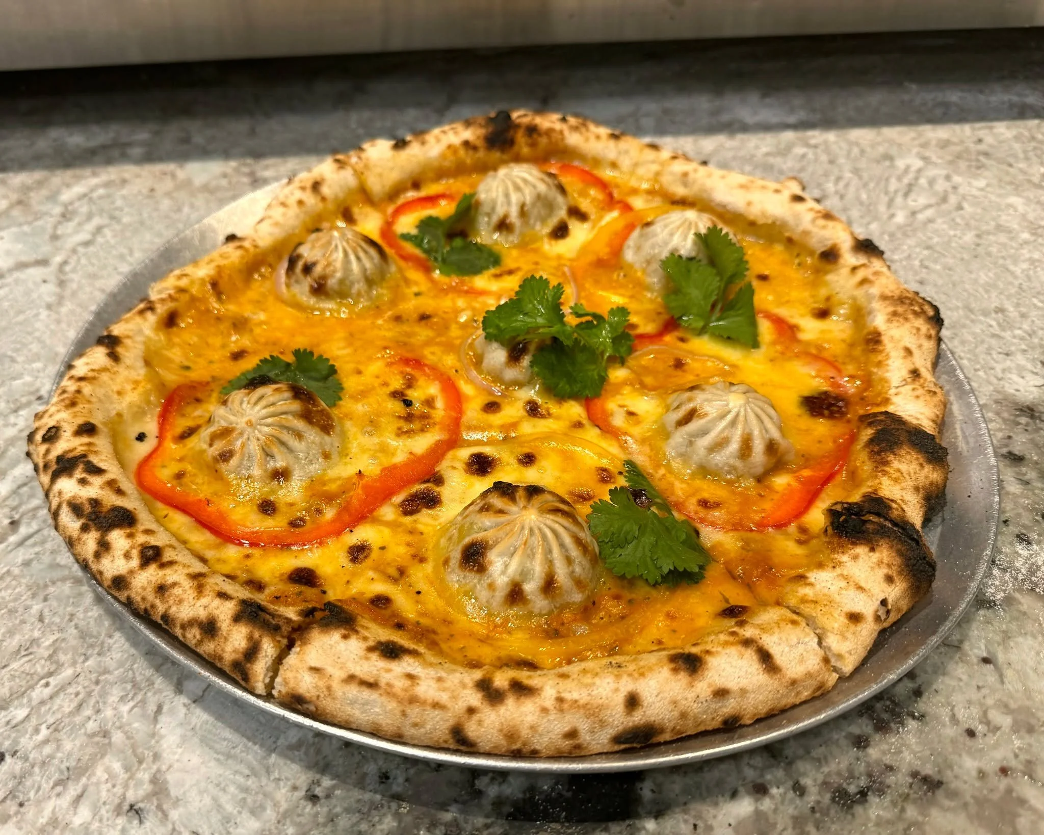 SOMETHING NEW JUST LANDED ON THE SPECIALS BOARD &mdash; THE MOMO PIZZA. Nepalese chicken dumplings, spicy chutney, capsicum and onion on a crisp base for $30. 

Perfect to share over a few drinks or kick back with in the courtyard. Around for the nex