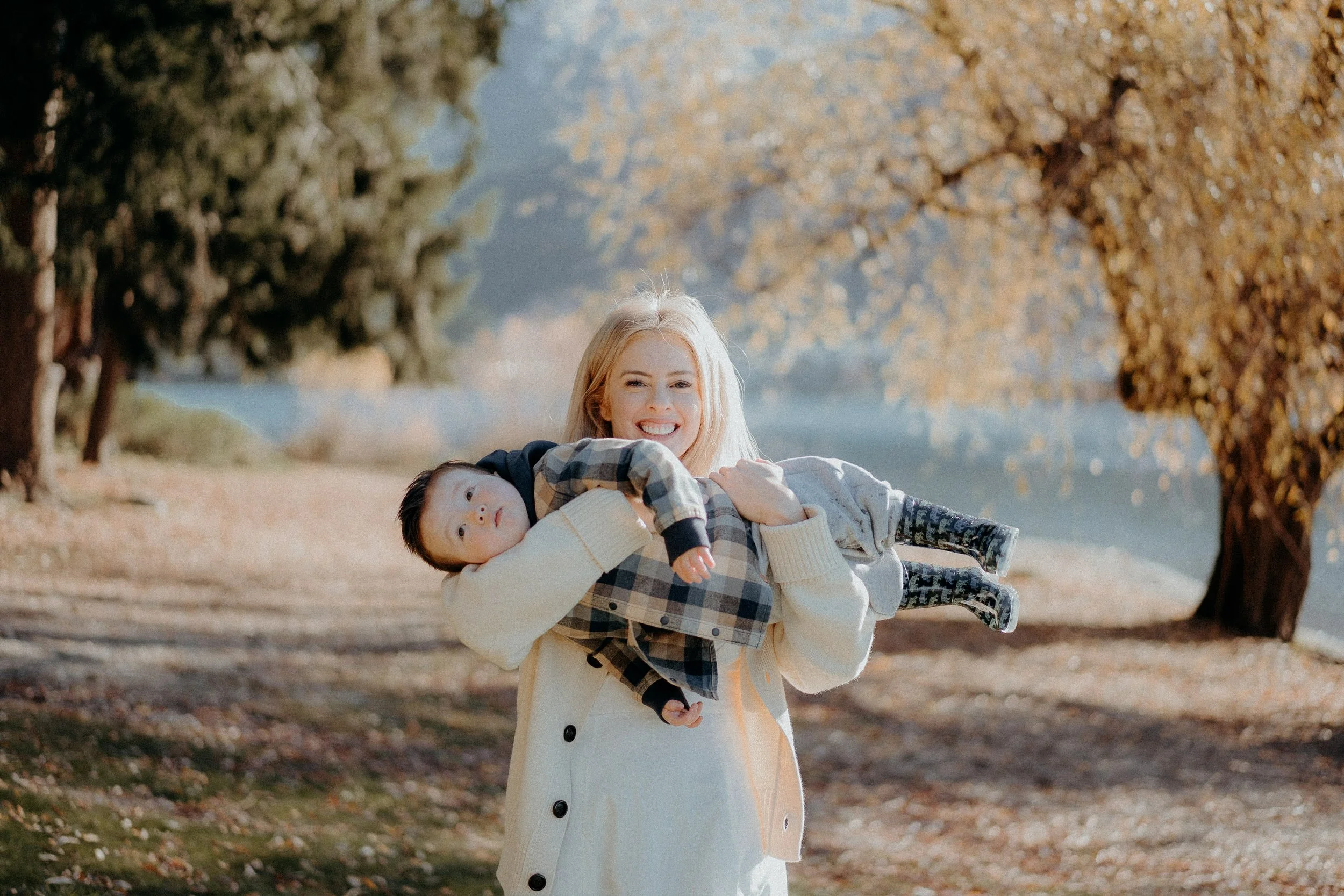 mum holding son sideways playfully for photo