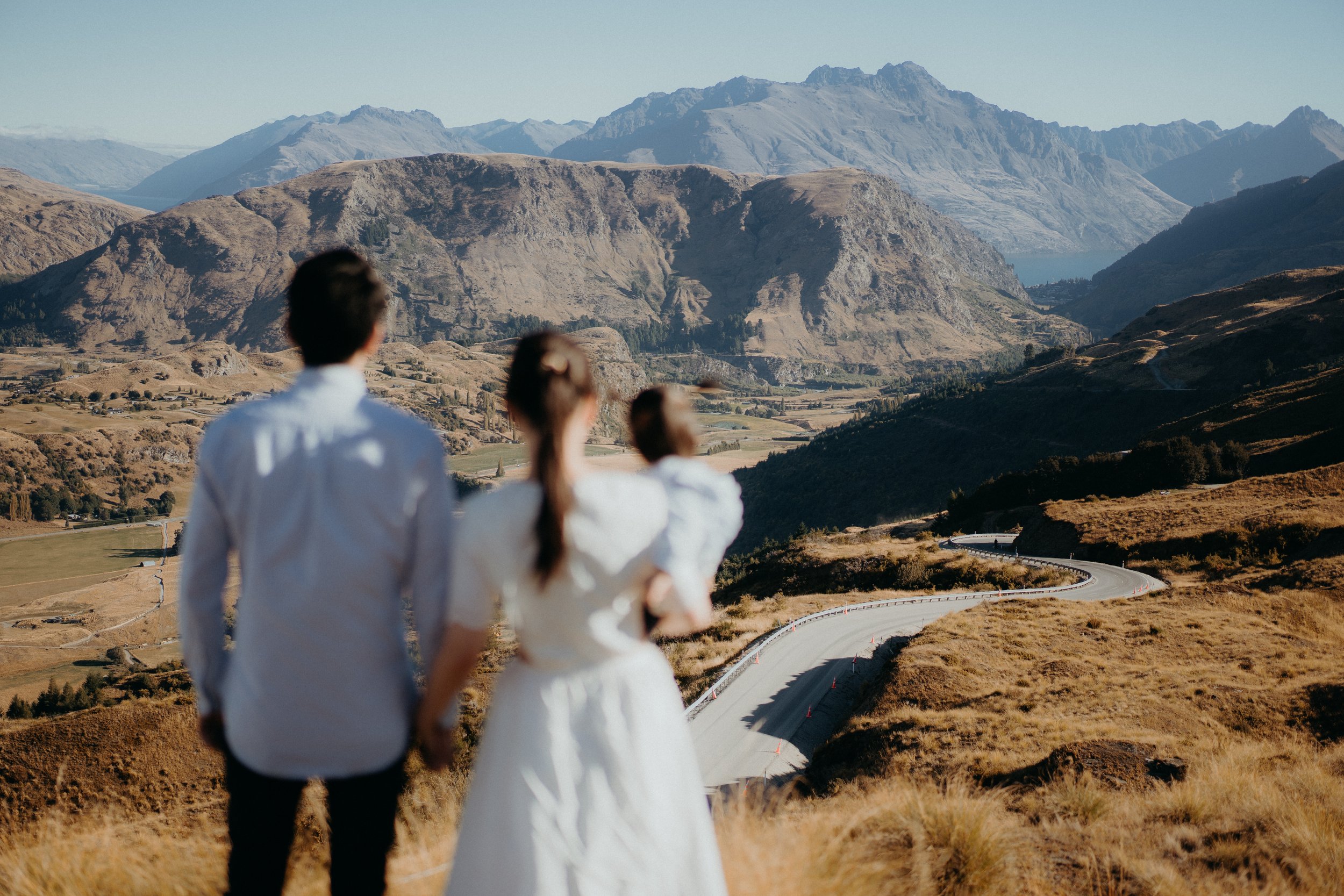 Family looking out and admiring the summertime view of the whakatipu basin