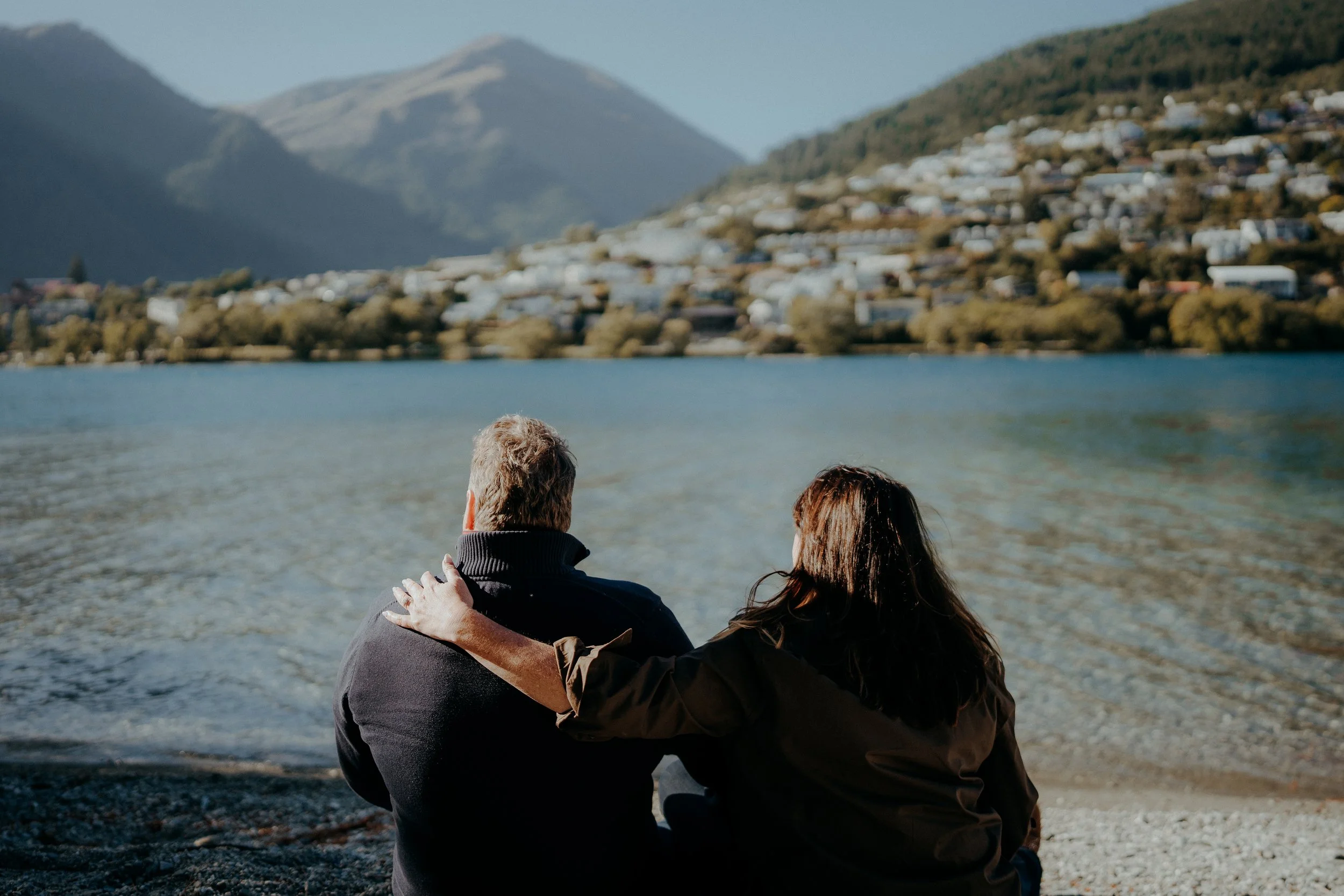 couple looking out at lake whakatipu
